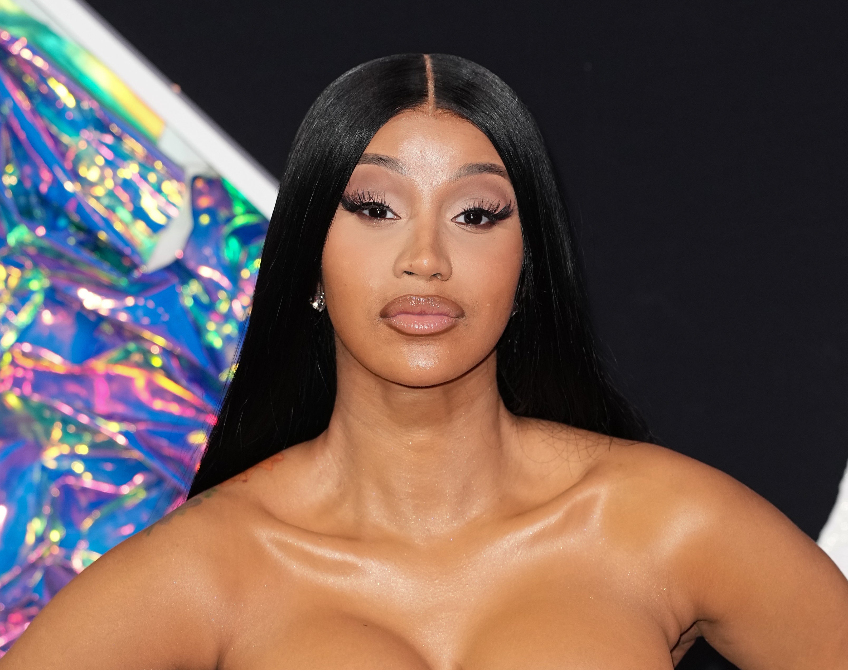 Cardi B wearing a strapless, metallic patterned gown on the red carpet