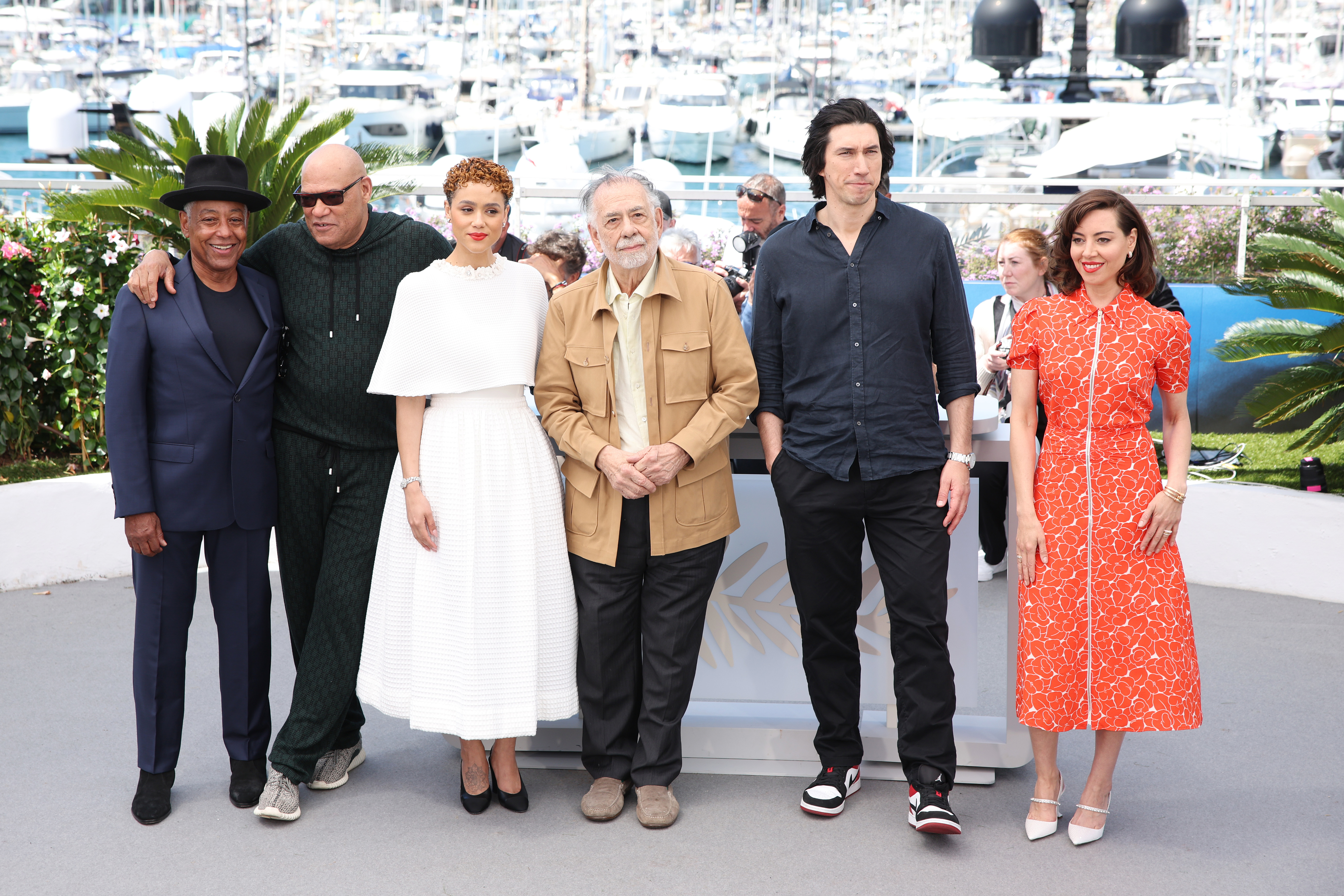Giancarlo Esposito, Laurence Fishburne, Nathalie Emmanuel, Francis Ford Coppola, Adam Driver, and Aubrey Plaza pose outdoors near a marina