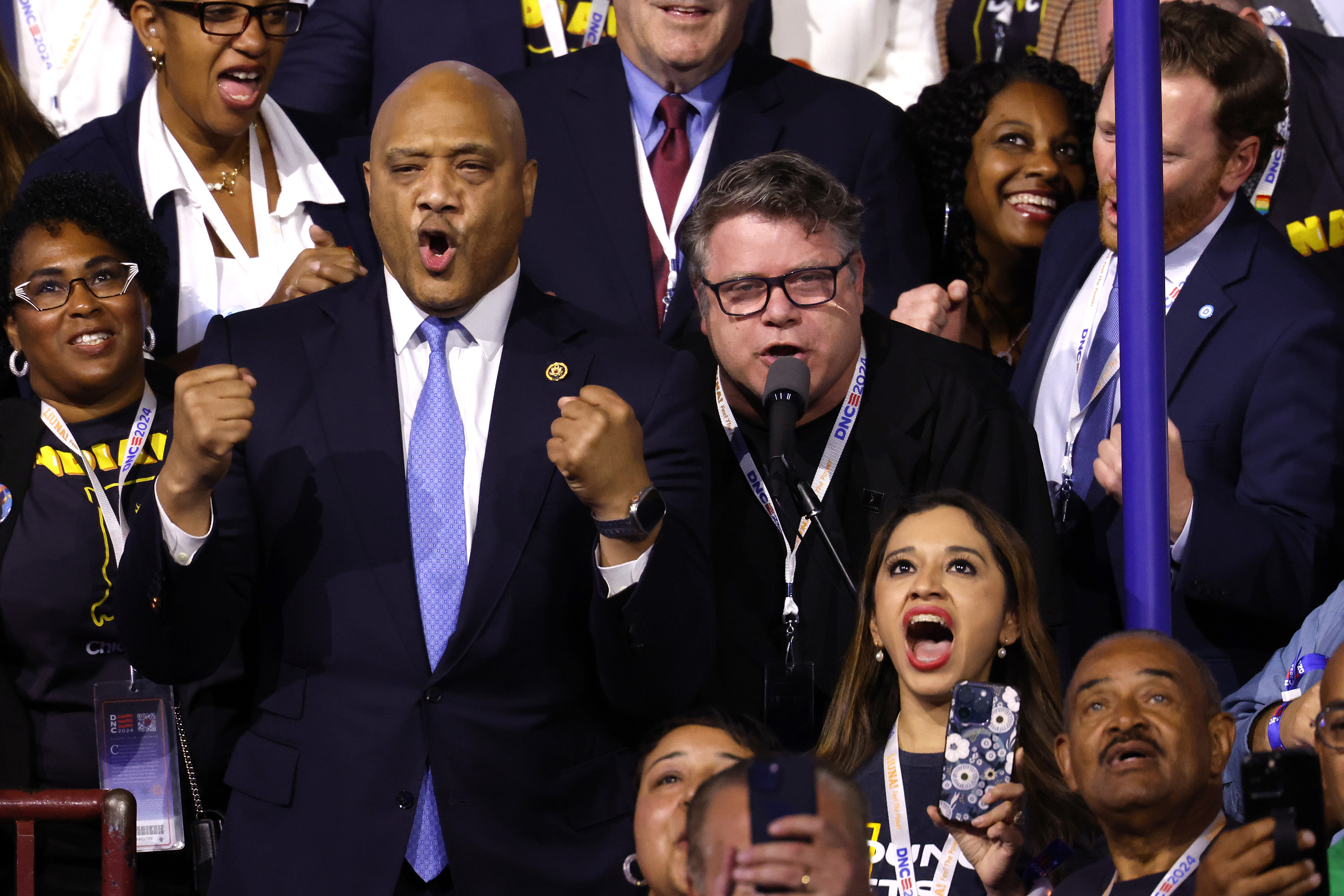 Congressman André Carson, Sean Astin, and others cheer and celebrate at an event