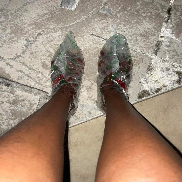 Person's feet covered in plastic wrap