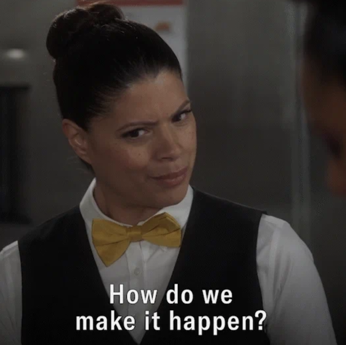 A waitress on a tv show looks quizzically at someone off-camera. Text reads, How do we make it happen
