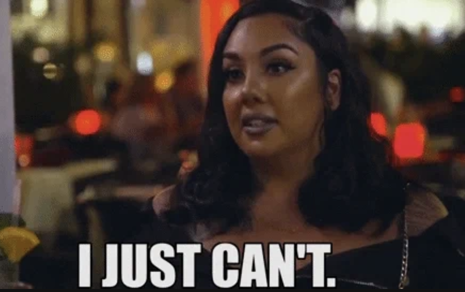 A woman frustrated while seated at a table. Text overlay says, I JUST CAN'T