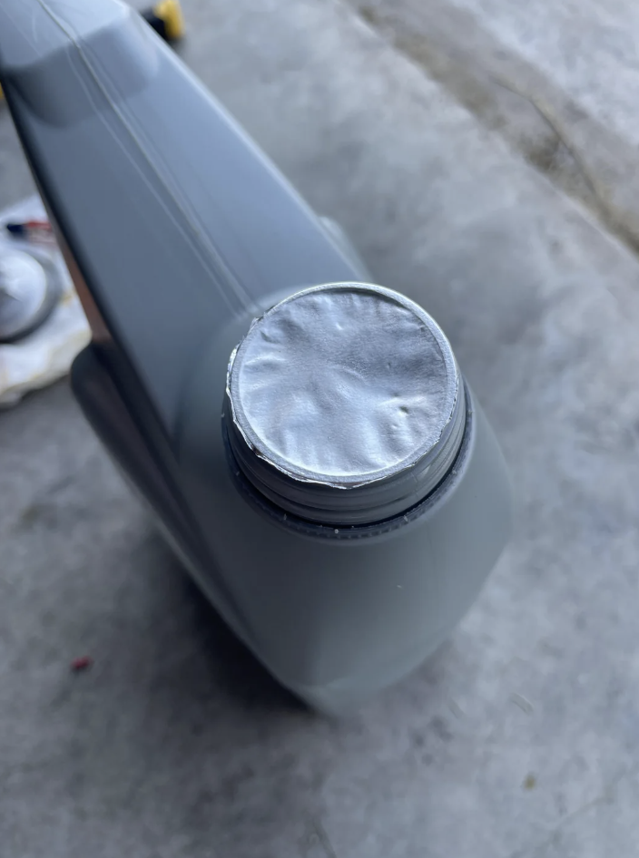 A sealed plastic container with a metallic foil covering the opening