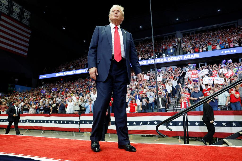 Donald Trump at a rally standing on a stage