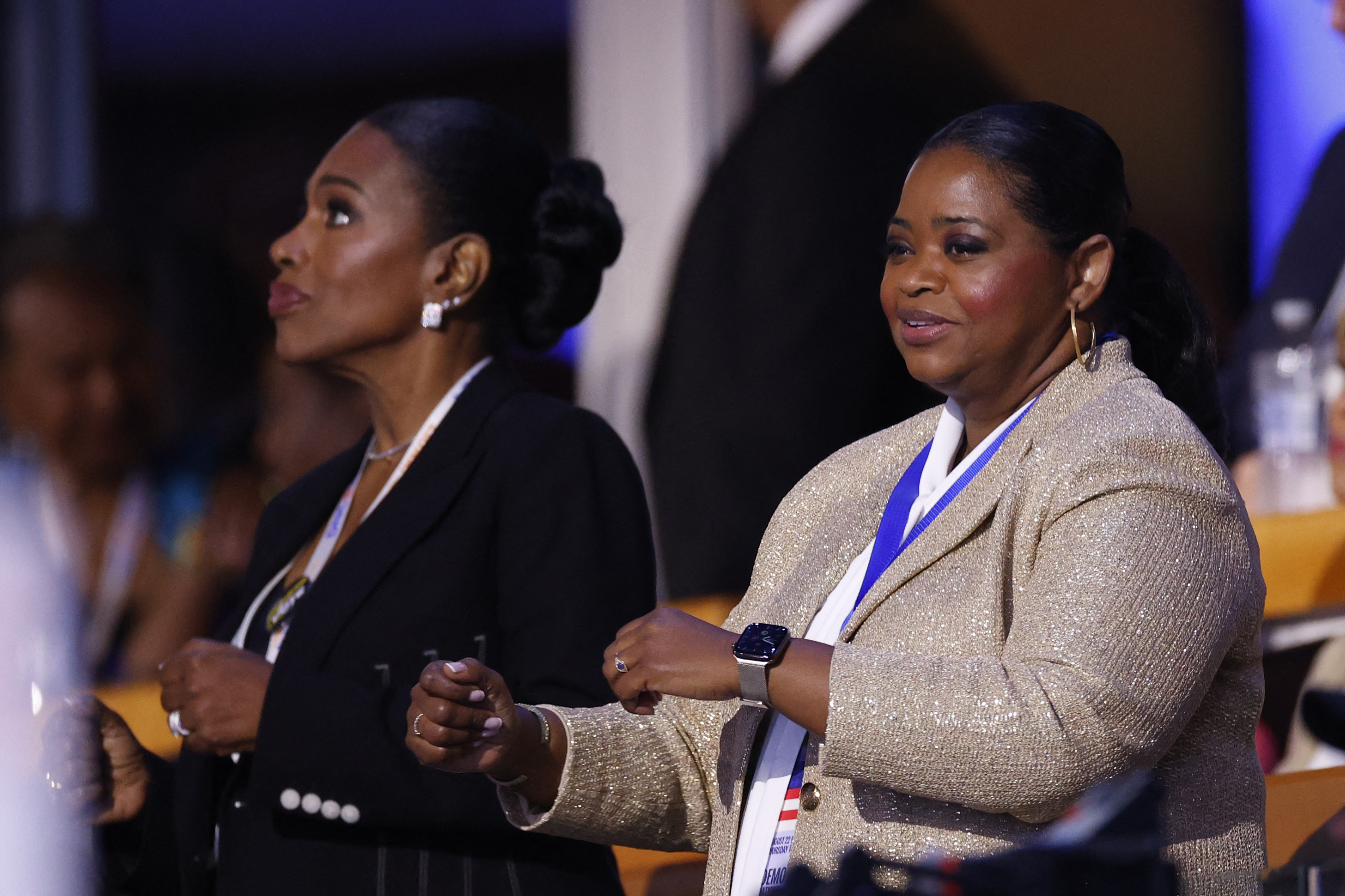 Sheryl Lee Ralph and Octavia Spencer at an event, both holding objects in their hands and wearing formal attire