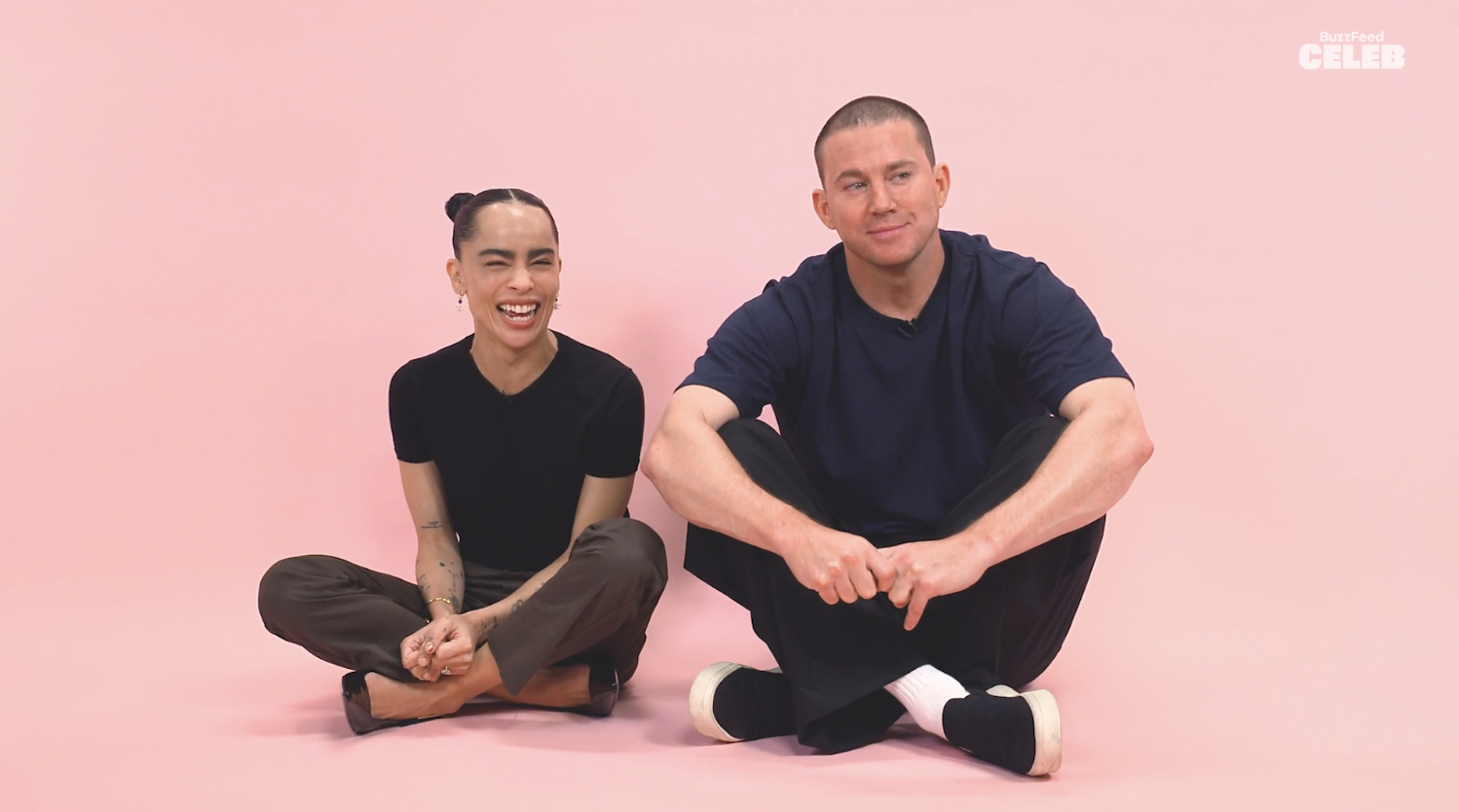 Josue Melendez and Channing Tatum sit on the floor against a plain background, smiling and casually dressed