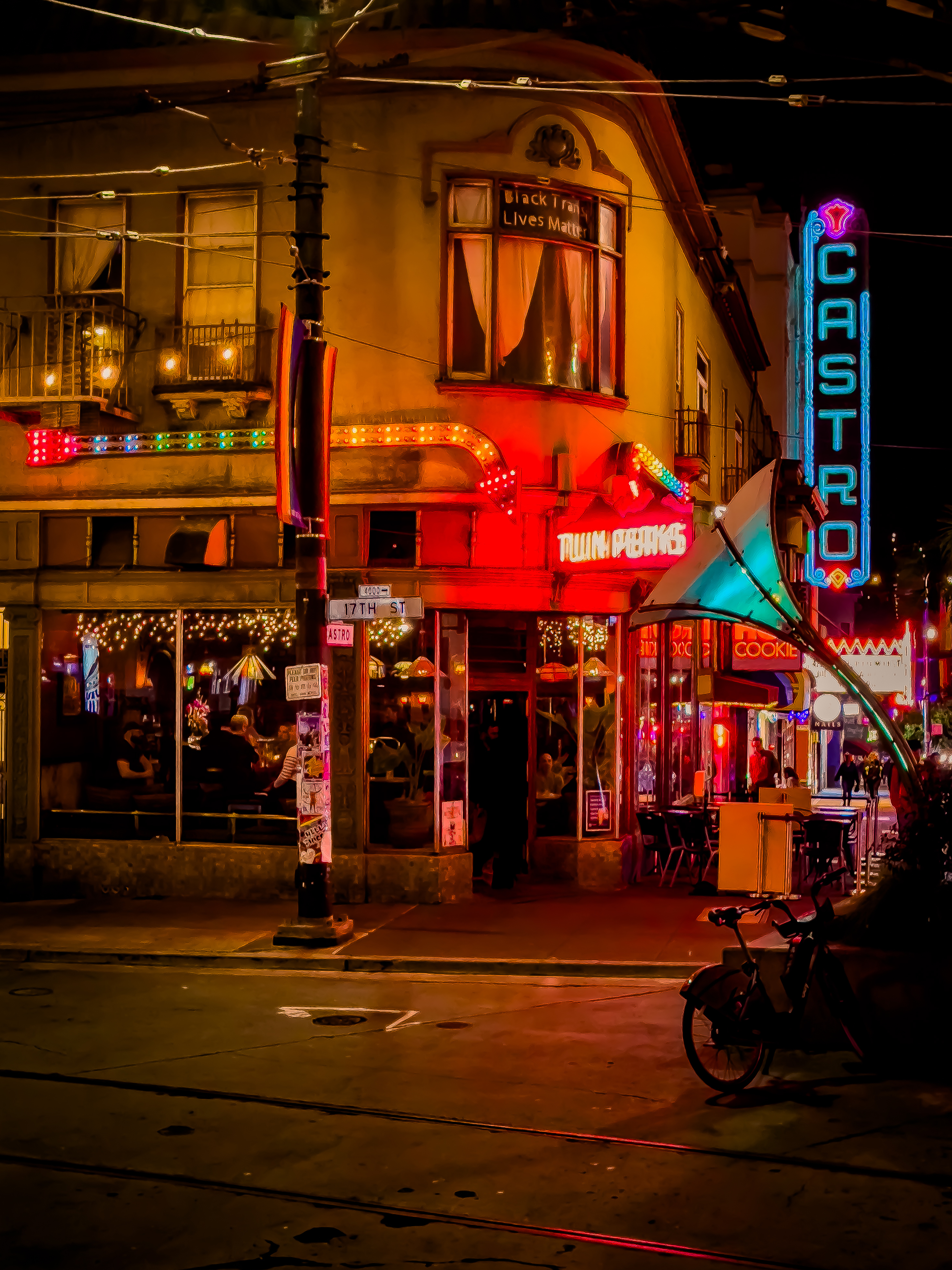 A lively evening scene outside Twin Peaks tavern in San Francisco's Castro District with colorful neon signs and people visible through the windows