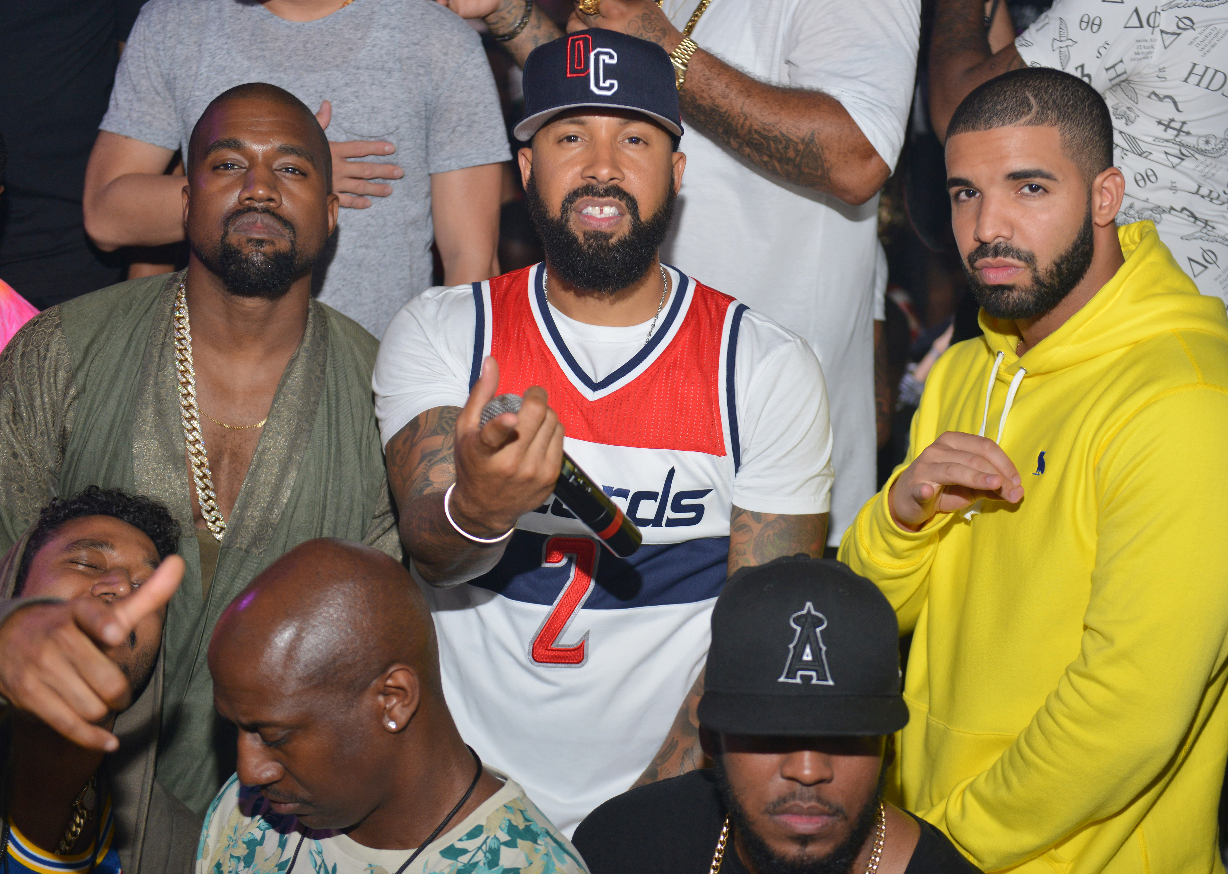 Kanye West, and Drake pose at a party.