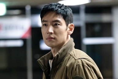 Ahn Bo-hyun in a scene from a TV show, wearing a casual jacket, looking serious