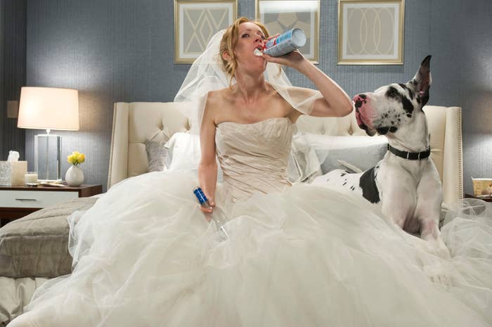 Leslie Mann wearing a wedding dress as she eats whipped cream out of a can and sits by a dog on her bed in "The Other Woman"
