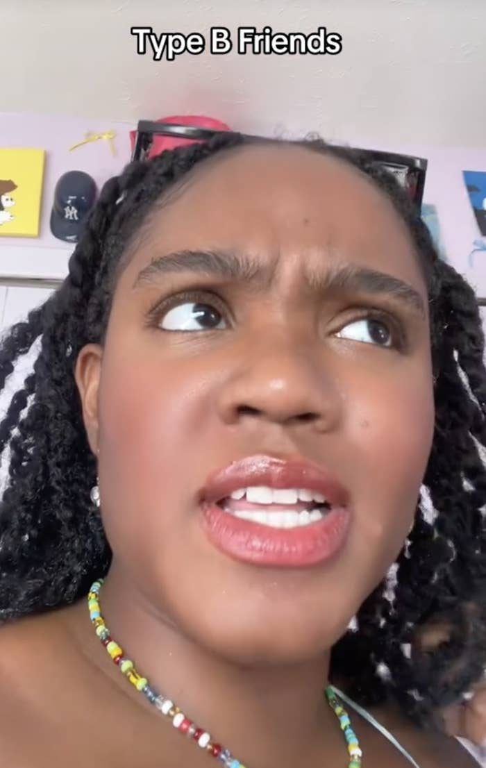 Dionna with braided hair, wearing a colorful beaded necklace, looks up with a slightly concerned expression. Text at the top reads: "Type B Friends"