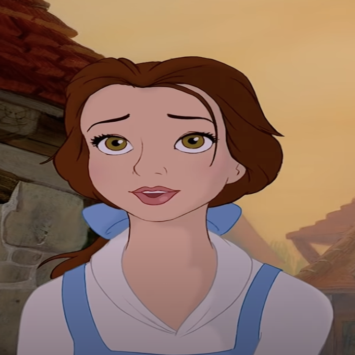 Belle from Beauty and the Beast stands in front of rustic buildings with a warm, slightly worried expression, wearing a simple dress with a blue ribbon in her hair