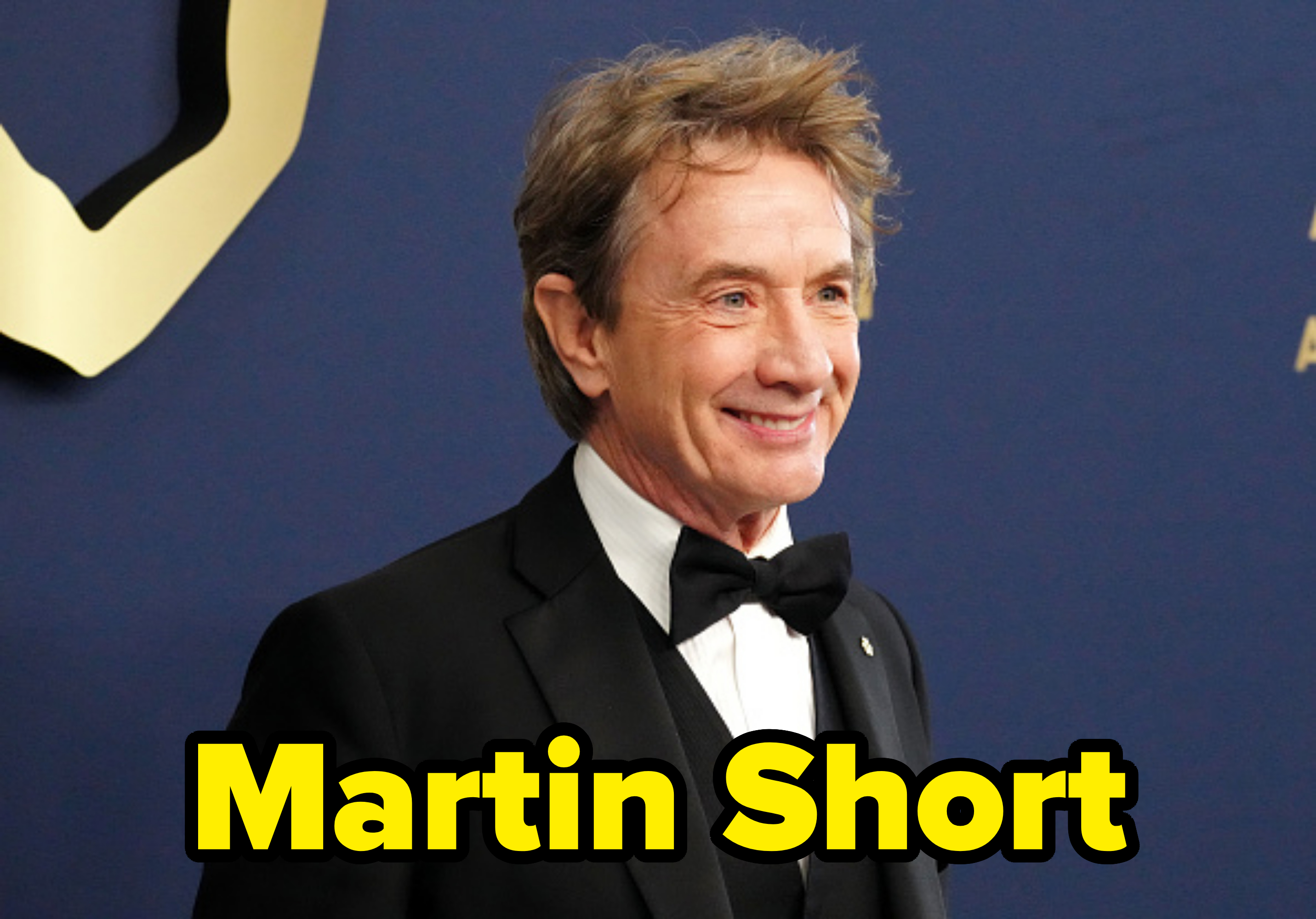 Martin Short on the red carpet wearing a classic black tuxedo with a bow tie