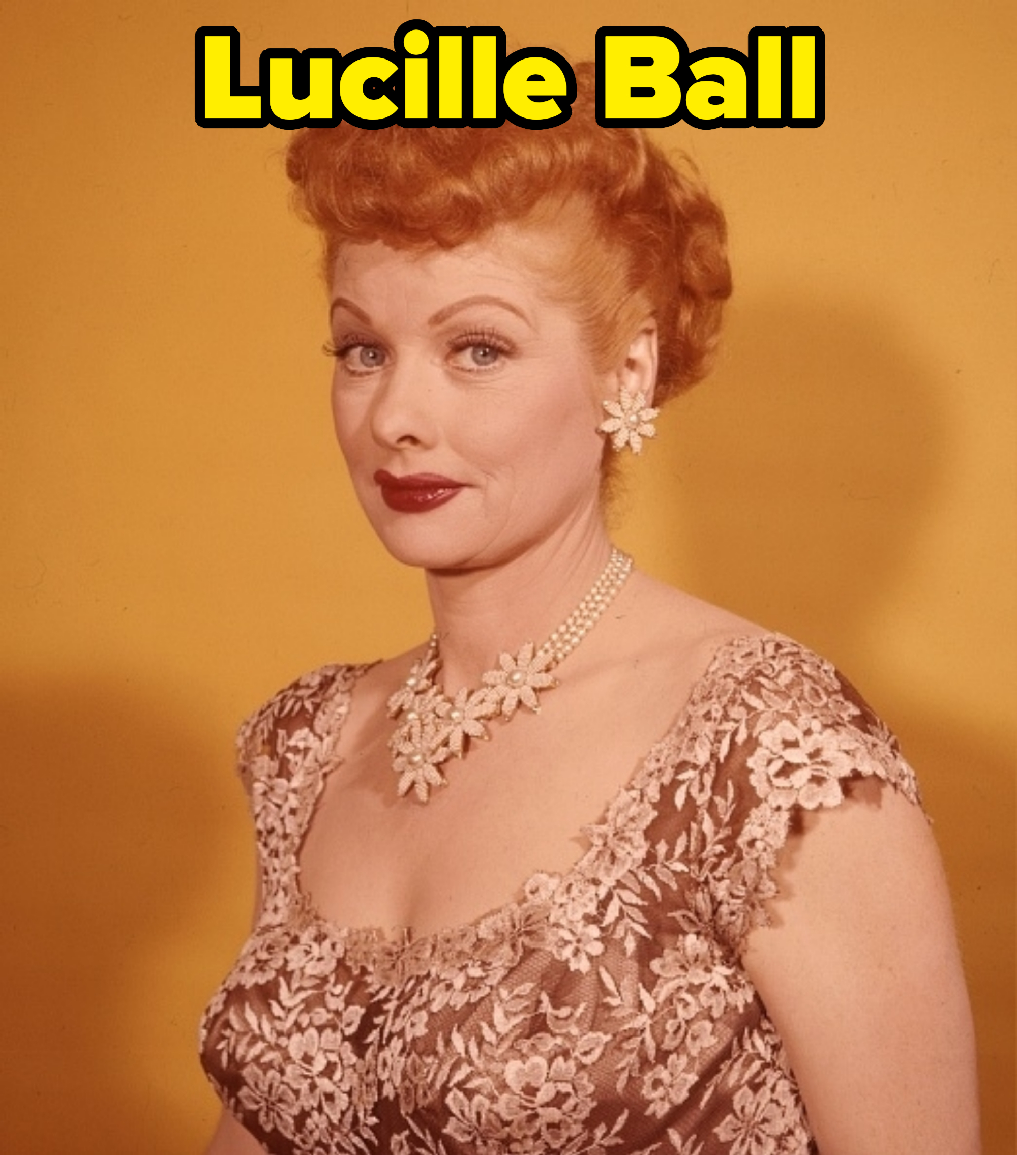 Lucille Ball wearing a floral lace dress, with matching floral earrings and necklace, against a plain background