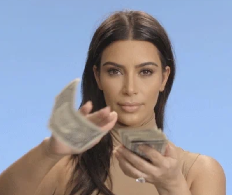 Kim Kardashian is dressed in a sleeveless top, holding and throwing cash towards the camera in this internet meme image