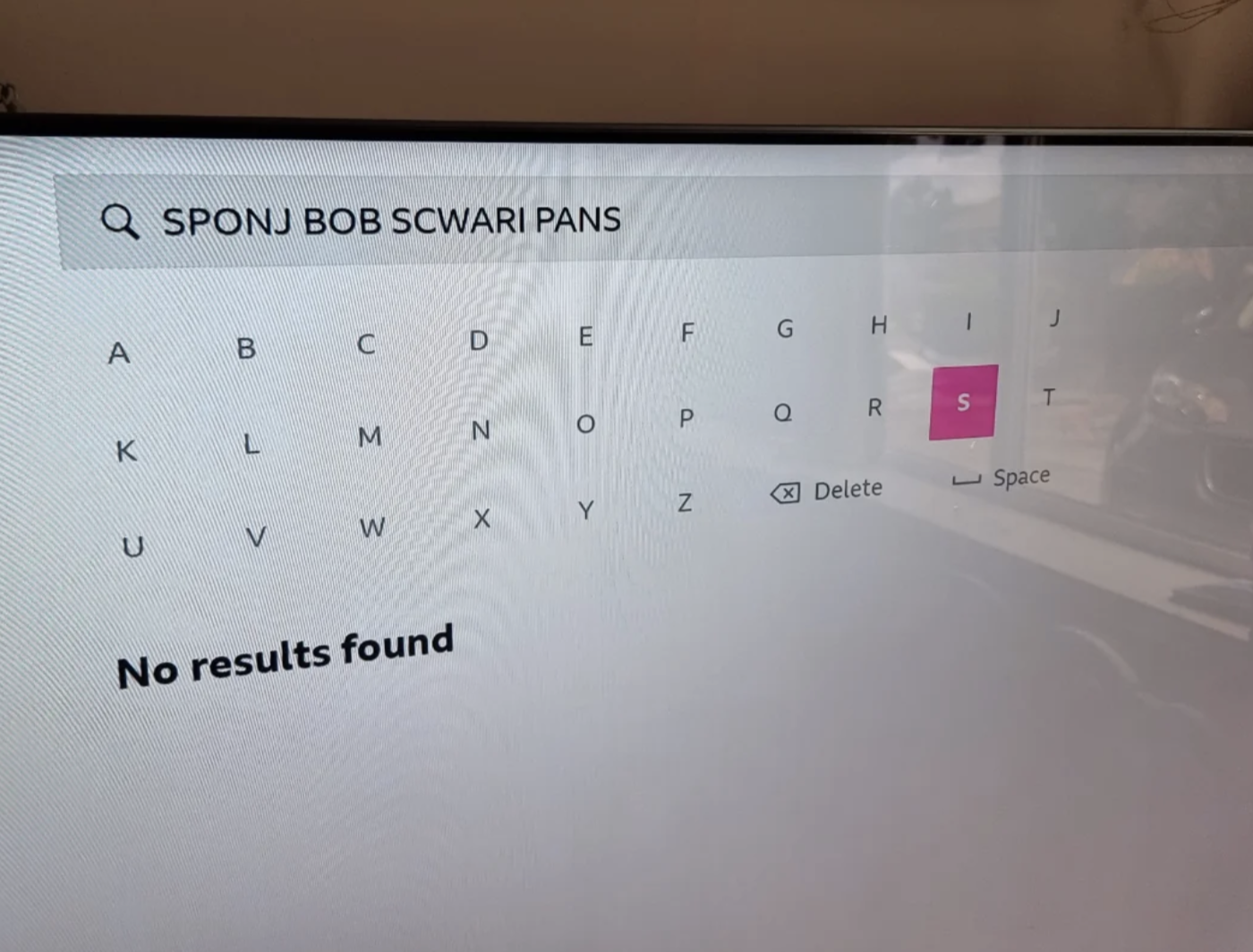 A television screen shows a search for "Sponj Bob Scwari Pans" with the message "No results found."
