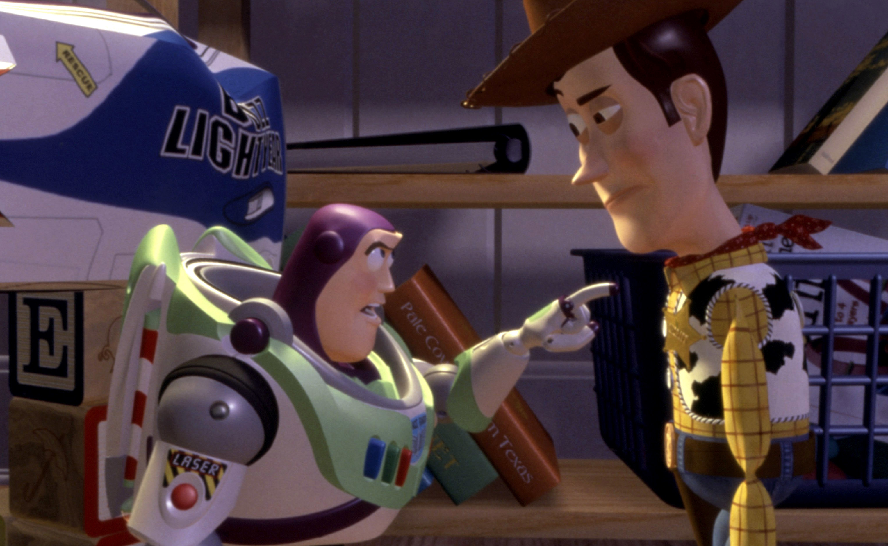Buzz Lightyear argues with Woody in a room filled with toys and books