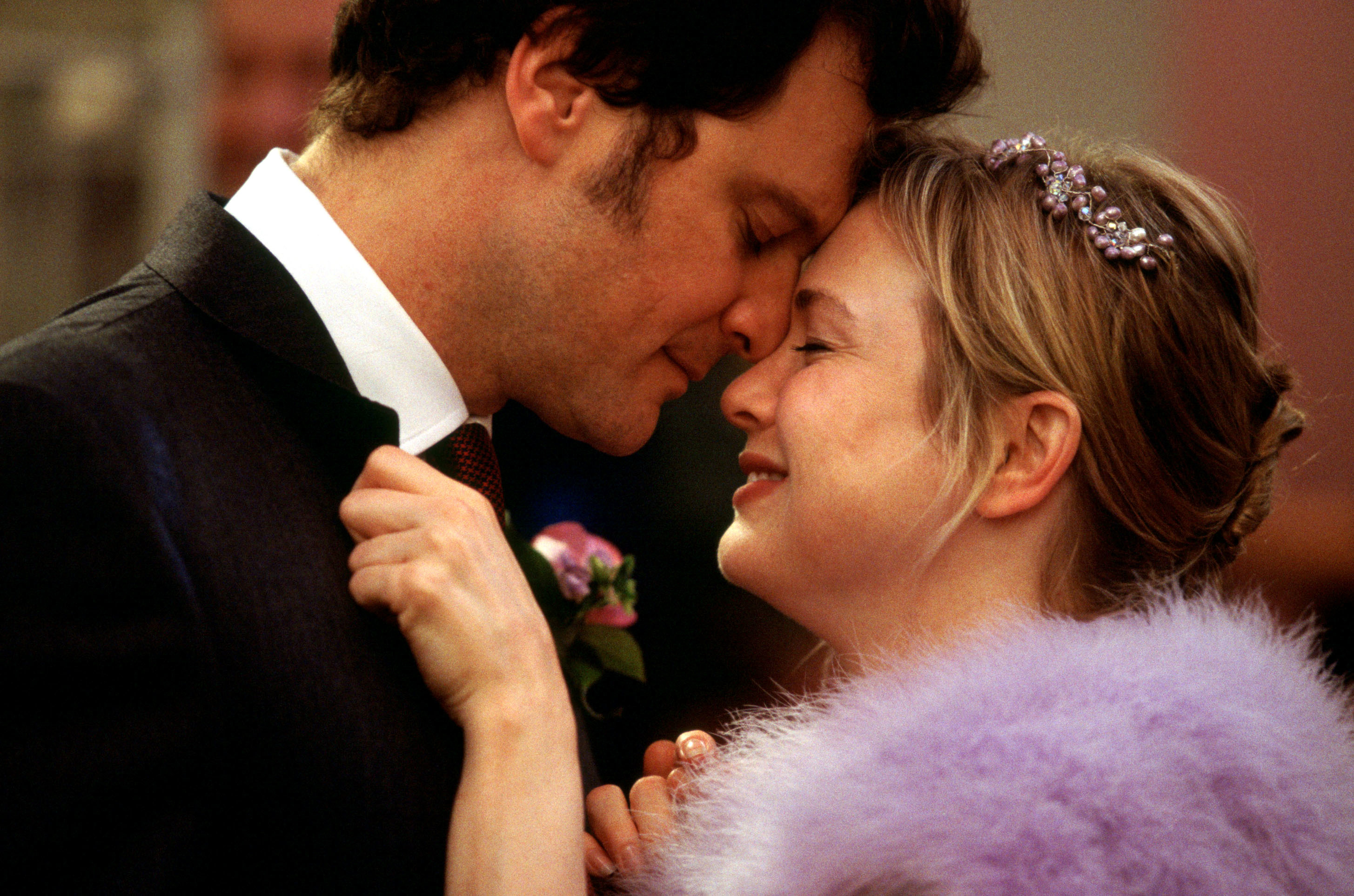Colin Firth and Renée Zellweger share an intimate moment, leaning in close, in a scene from the movie Bridget Jones's Diary
