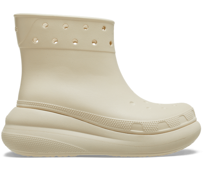 Beige slip-on rubber boot with a round toe, multiple ventilation holes at the top, and a thick platform sole