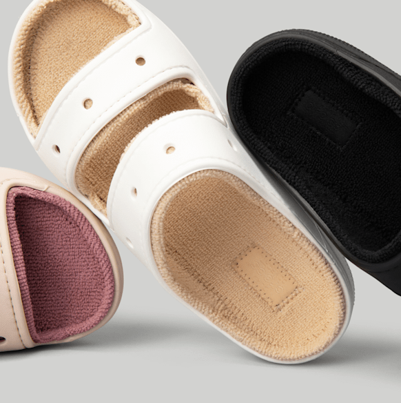 Three pairs of slippers are arranged, showcasing their different-colored footbeds and strap designs, perfect for a comfortable and stylish home footwear option