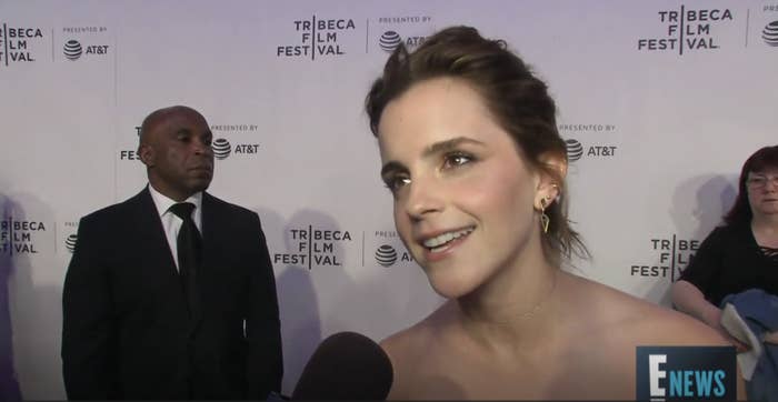 Emma Watson at Tribeca Film Festival, interviewed by E! News, wearing strapless dress with noticeable earrings