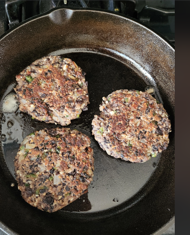 A Reddit post from user seriousseats displaying a pan with three black bean veggie burgers. The user recommends the recipe. The comment section is visible
