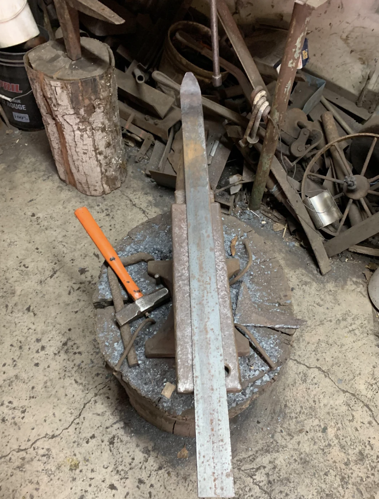 Reddit post by blacksmithn: "I'm kinda new to blacksmithing but I decided to take my hand at making a sword any tips?" with an image showing an anvil and metalworking tools