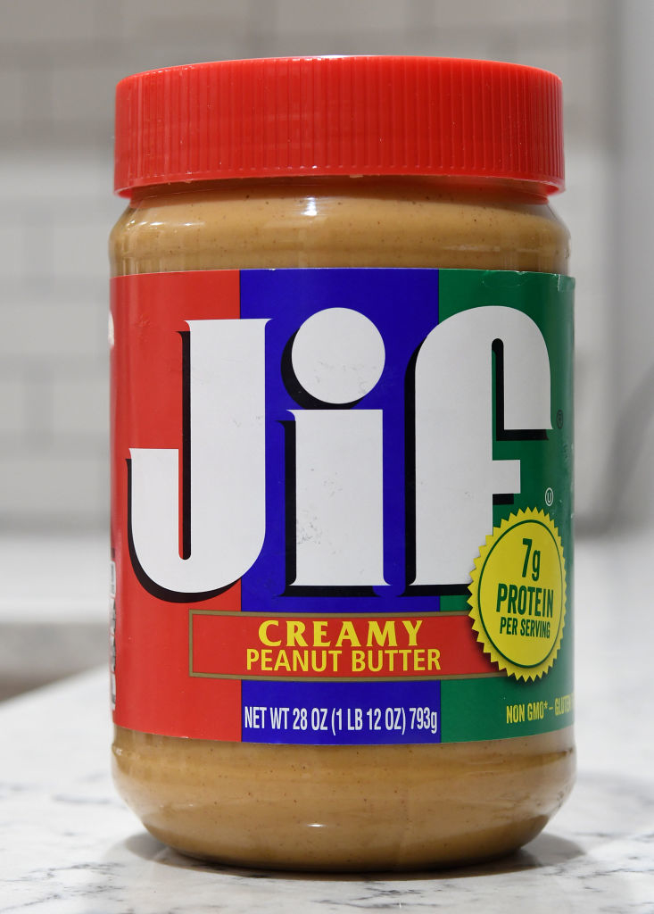 Jar of Jif creamy peanut butter, 28 oz, highlighting 7g of protein per serving, on a kitchen counter