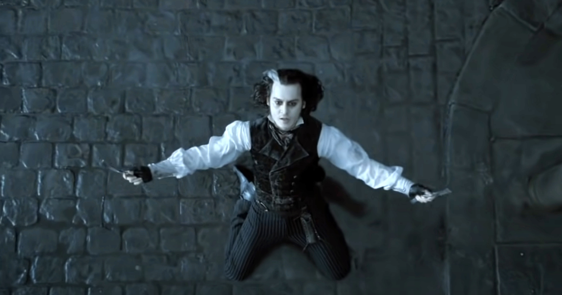 Johnny Depp as Sweeney Todd, wearing a Victorian-style outfit with a vest and striped pants, facing upwards and holding razors in both hands on a cobblestone street