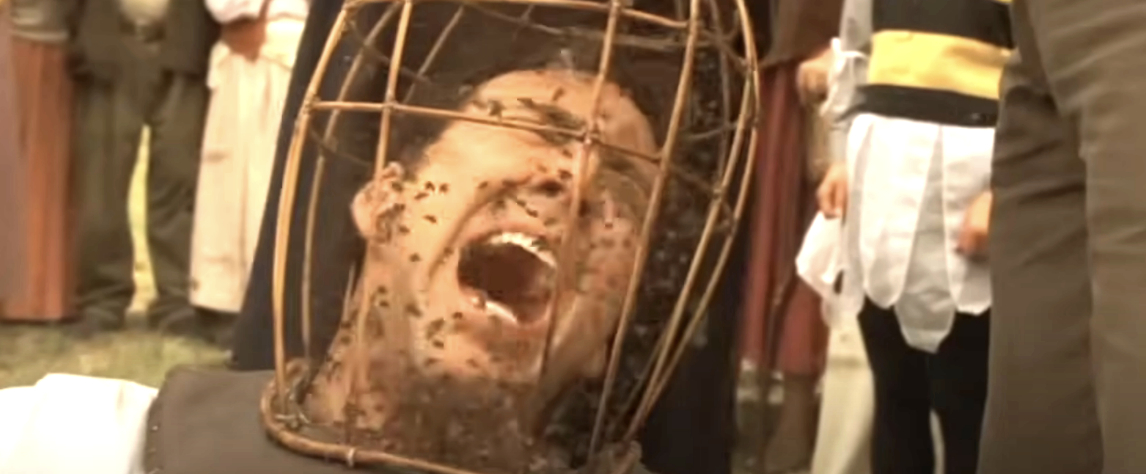 Nicolas Cage as Edward Malus in &quot;The Wicker Man&quot; screams with a cage of bees over his head