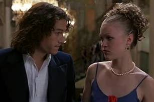 Heath Ledger and Julia Stiles in formal attire, looking at each other, from the film 10 Things I Hate About You