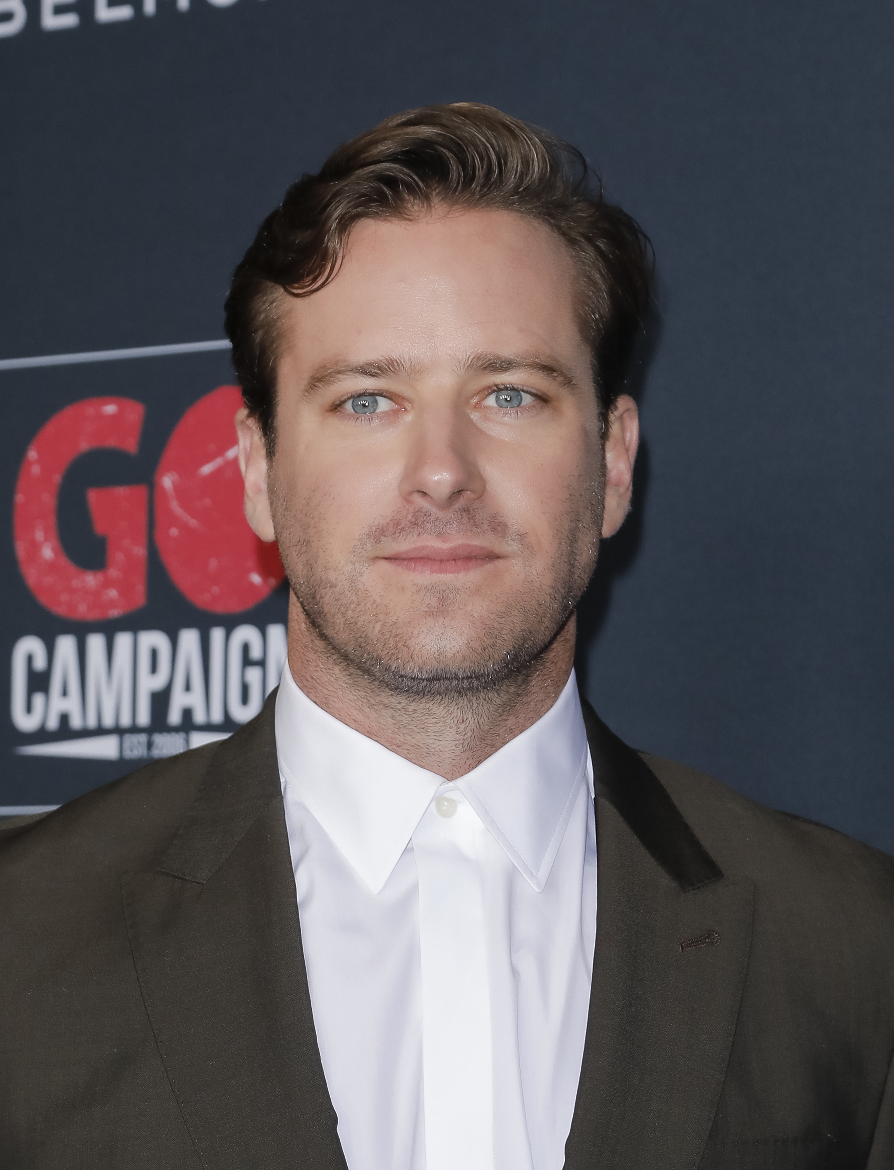 Armie Hammer in a suit jacket and dress shirt at the GO Campaign event