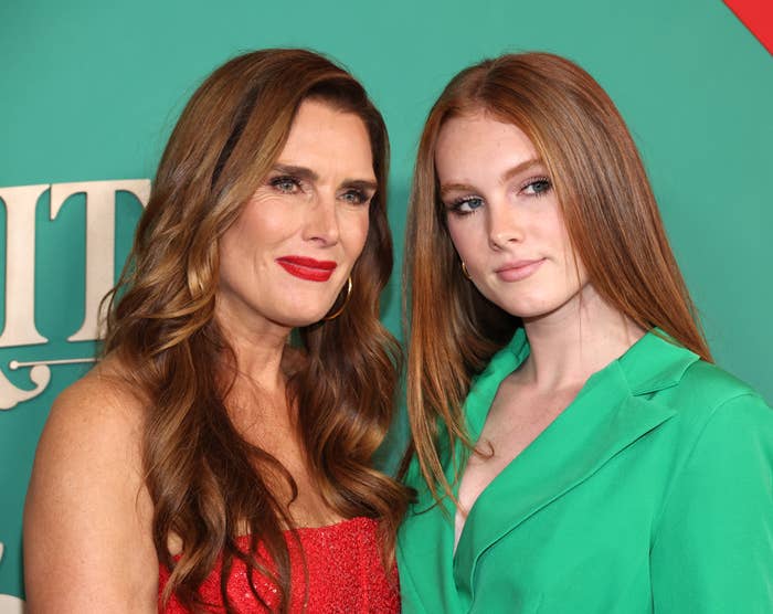 Brooke Shields and Rowan Henchy pose together, Brooke in a dress and Rowan in a blazer, on a red carpet event