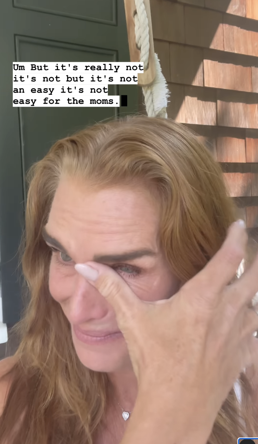 Brooke Shields wiping a tear from her eye as she mentions both her children have left for college in an Instagram post