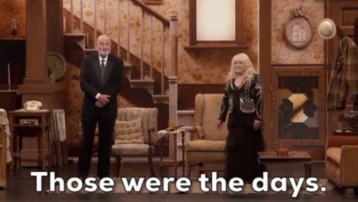 Rob Reiner and Sallie Struthers stand on a retro-themed stage, smiling; subtitles read &quot;Those were the days.&quot;