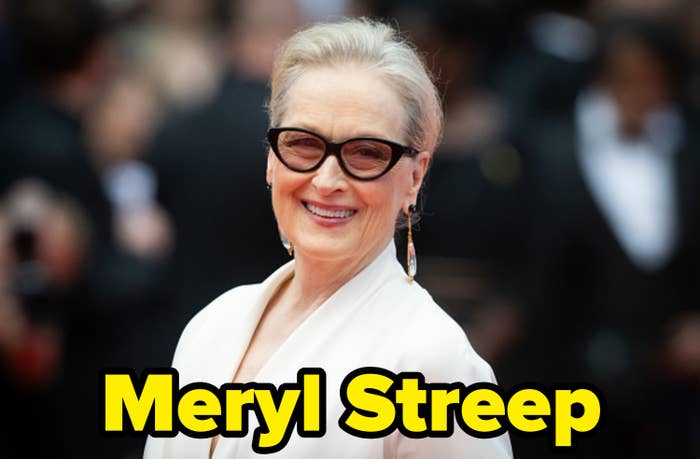 Meryl Streep is on the red carpet, wearing a chic white outfit and large dark sunglasses, with her hair swept back and classy earrings
