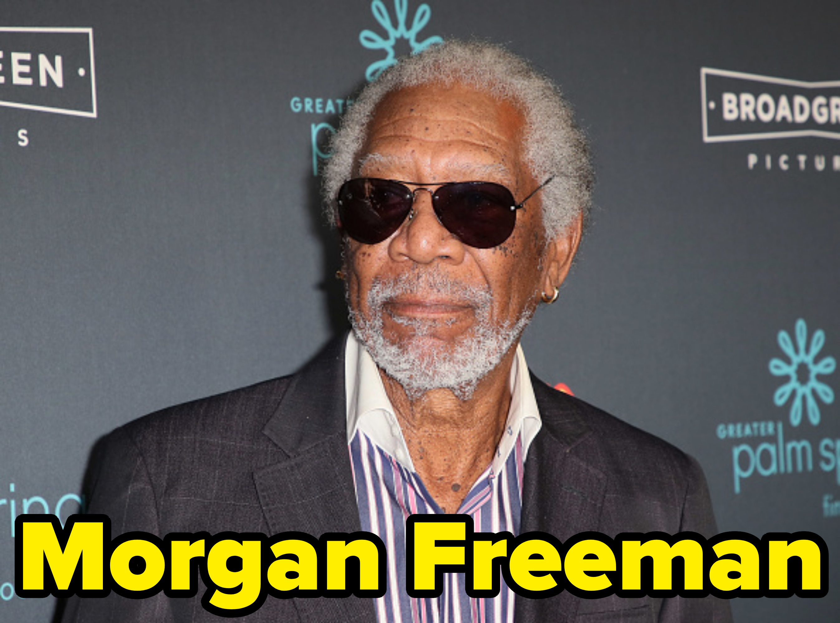 Morgan Freeman wearing a striped shirt under a suit jacket and sunglasses at a Broad Green Pictures event