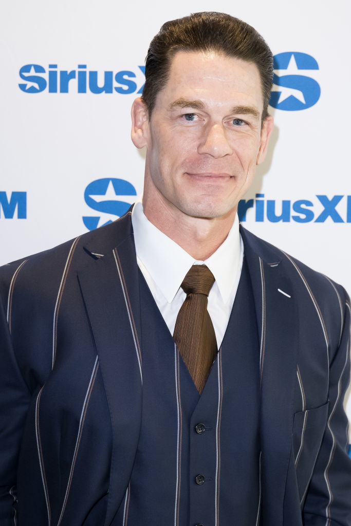 John Cena in a pinstripe suit, dress shirt, and tie at a SiriusXM event