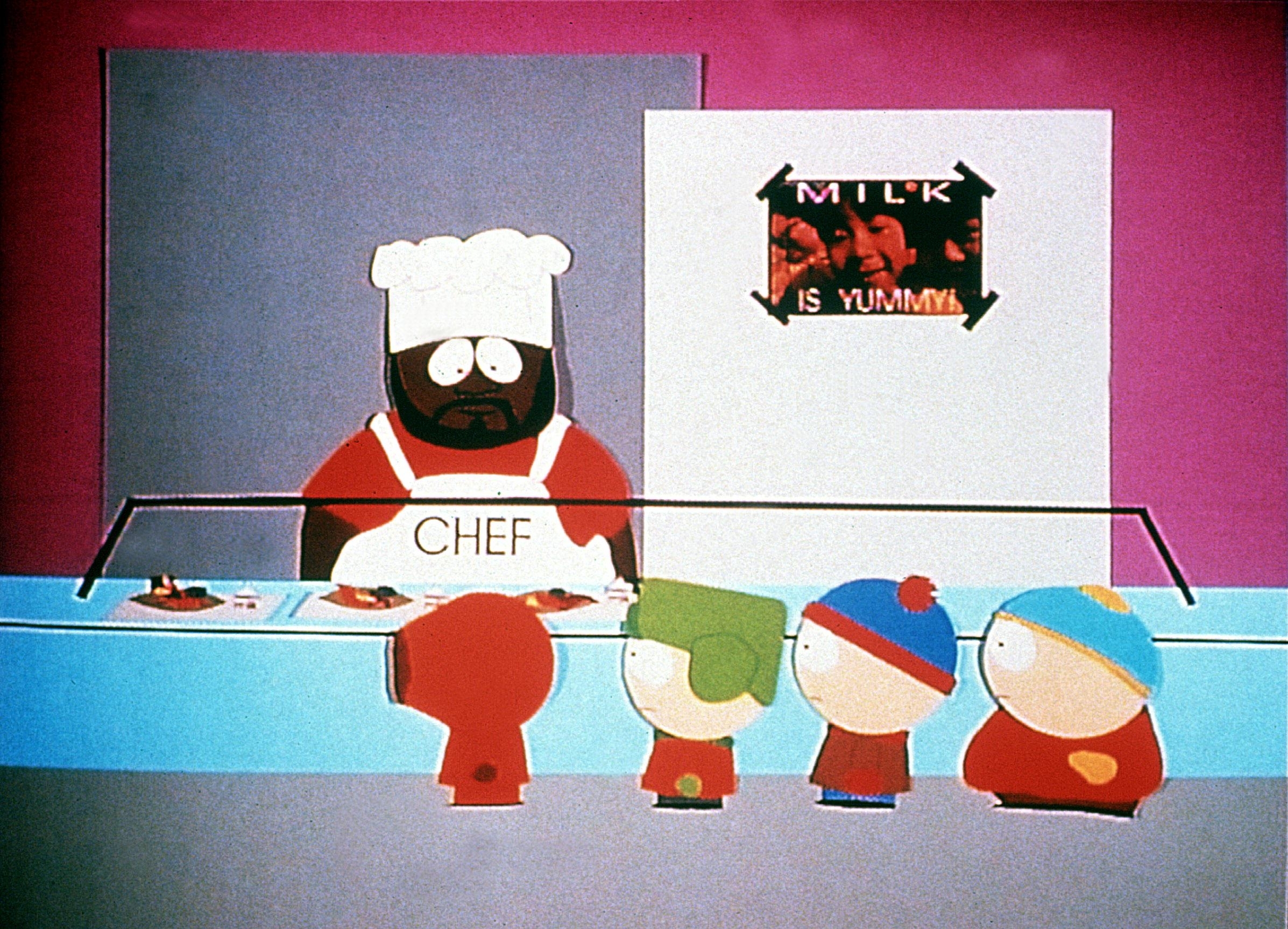 Chef, Cartman, Kyle, Stan, and Kenny from South Park at the school cafeteria, with Chef serving food behind the counter and a "Milk Is Yummy" poster in the background