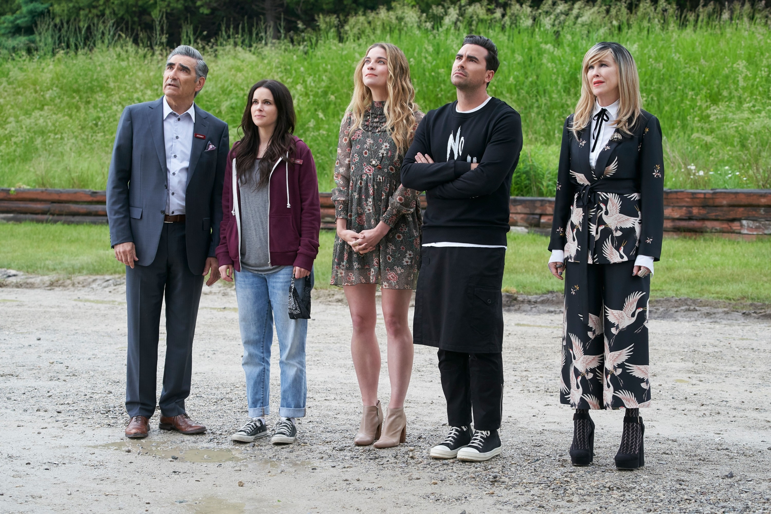 Eugene Levy, Emily Hampshire, Annie Murphy, Dan Levy, and Catherine O'Hara standing side by side outdoors, in casual to semi-casual attire