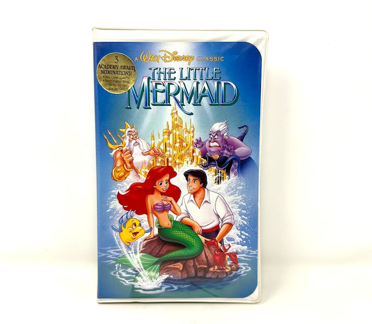 Cover of the VHS tape of "The Little Mermaid." Features Ariel, Prince Eric, Flounder, King Triton, and Ursula, with the underwater kingdom in the background