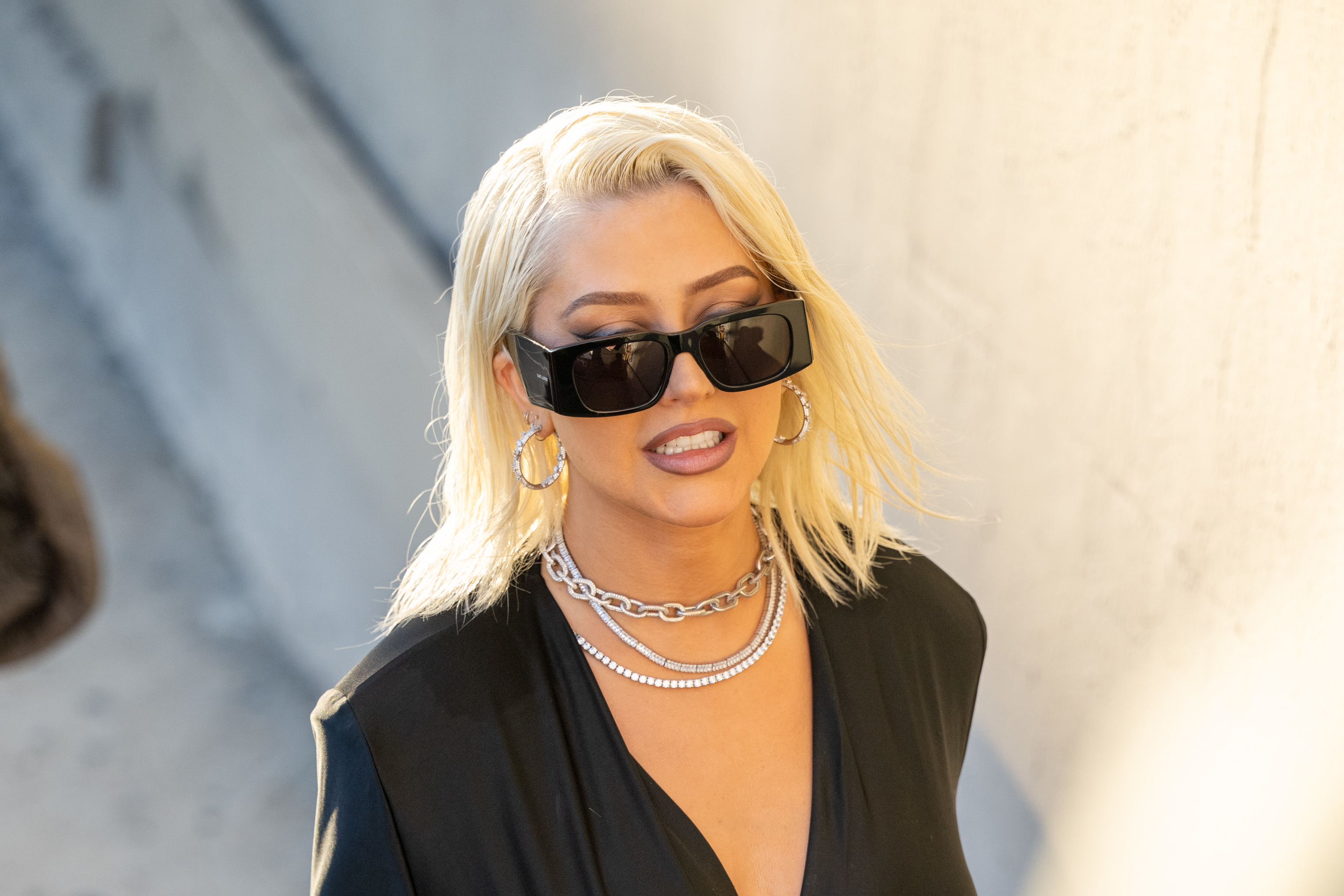 Christina Aguilera wearing oversized sunglasses and layered necklaces