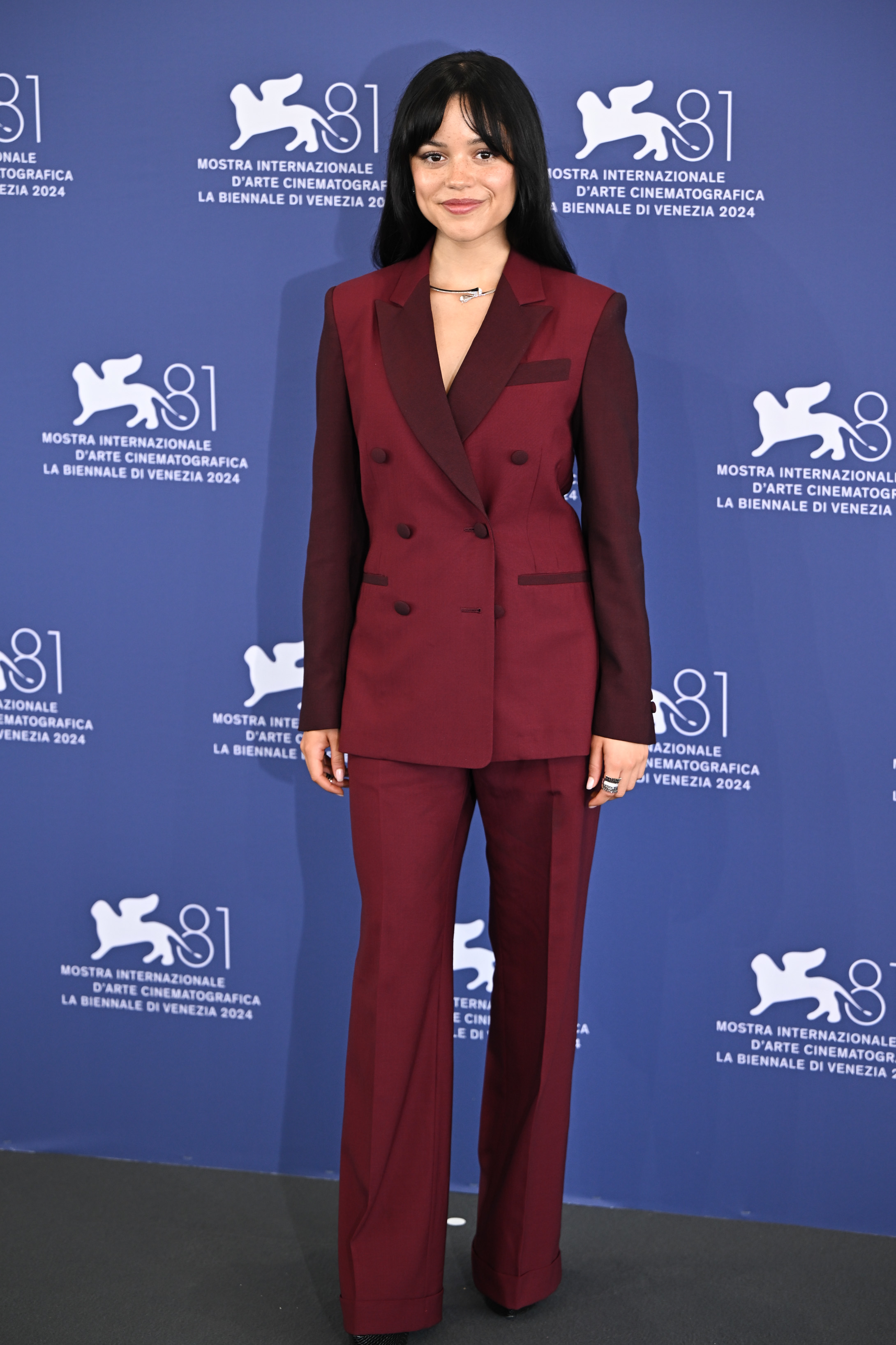 Jenna Ortega poses at the Venice Biennale 2024 wearing a double-breasted tailored suit