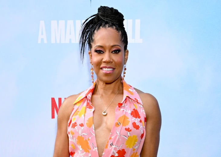 Regina King poses on the red carpet in a floral, ruffled dress at a premiere event