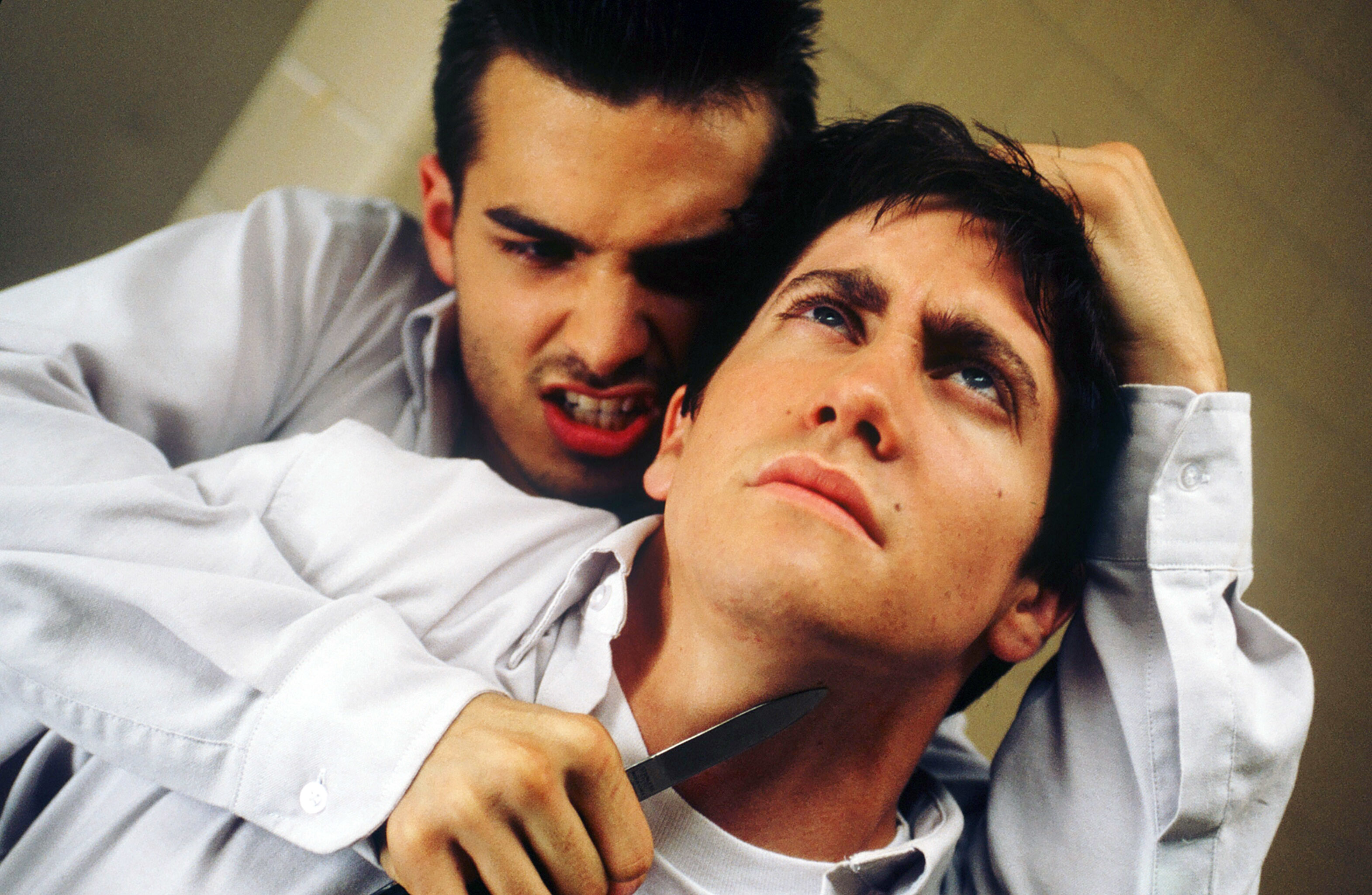 A scene from the movie &quot;Donnie Darko&quot; shows a tense moment with a character, played by Jerad Anderson, threatening another character, played by Jake Gyllenhaal, with a knife