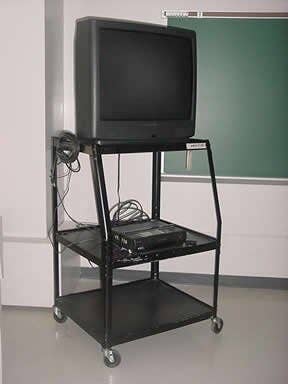 Old TV on a cart with a VCR below, reminiscent of classroom setups in the late 1990s to early 2000s