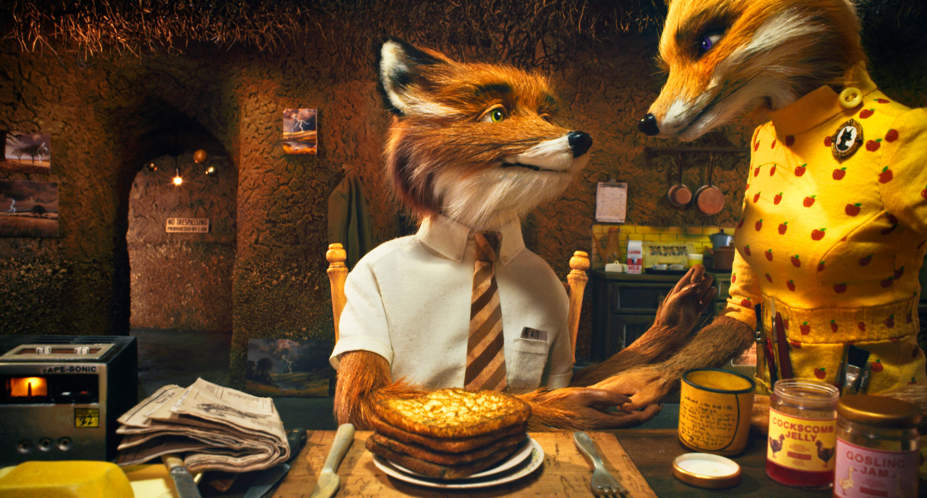 Animation scene from &quot;Fantastic Mr. Fox&quot; with Mr. Fox in a shirt and tie, and Mrs. Fox in a polka-dot dress, having breakfast with pancakes on the table