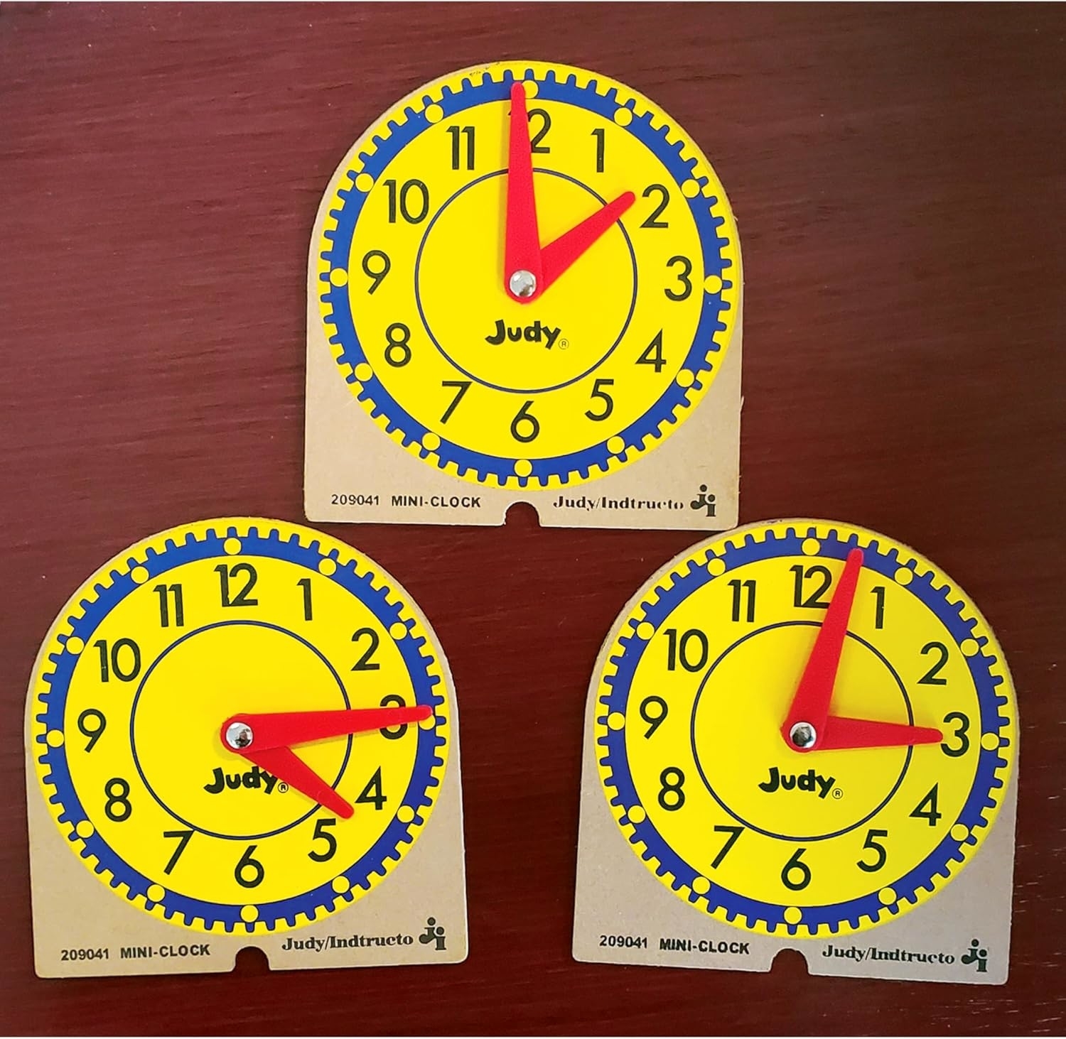 Three mini-clock educational tools branded &quot;Judy,&quot; each displaying different times: 3:00, 2:00, and 6:20