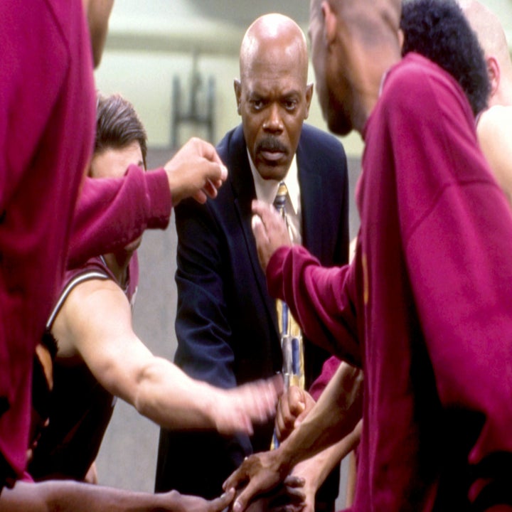 Samuel L. Jackson in a coaching huddle with a basketball team wearing warm-up shirts