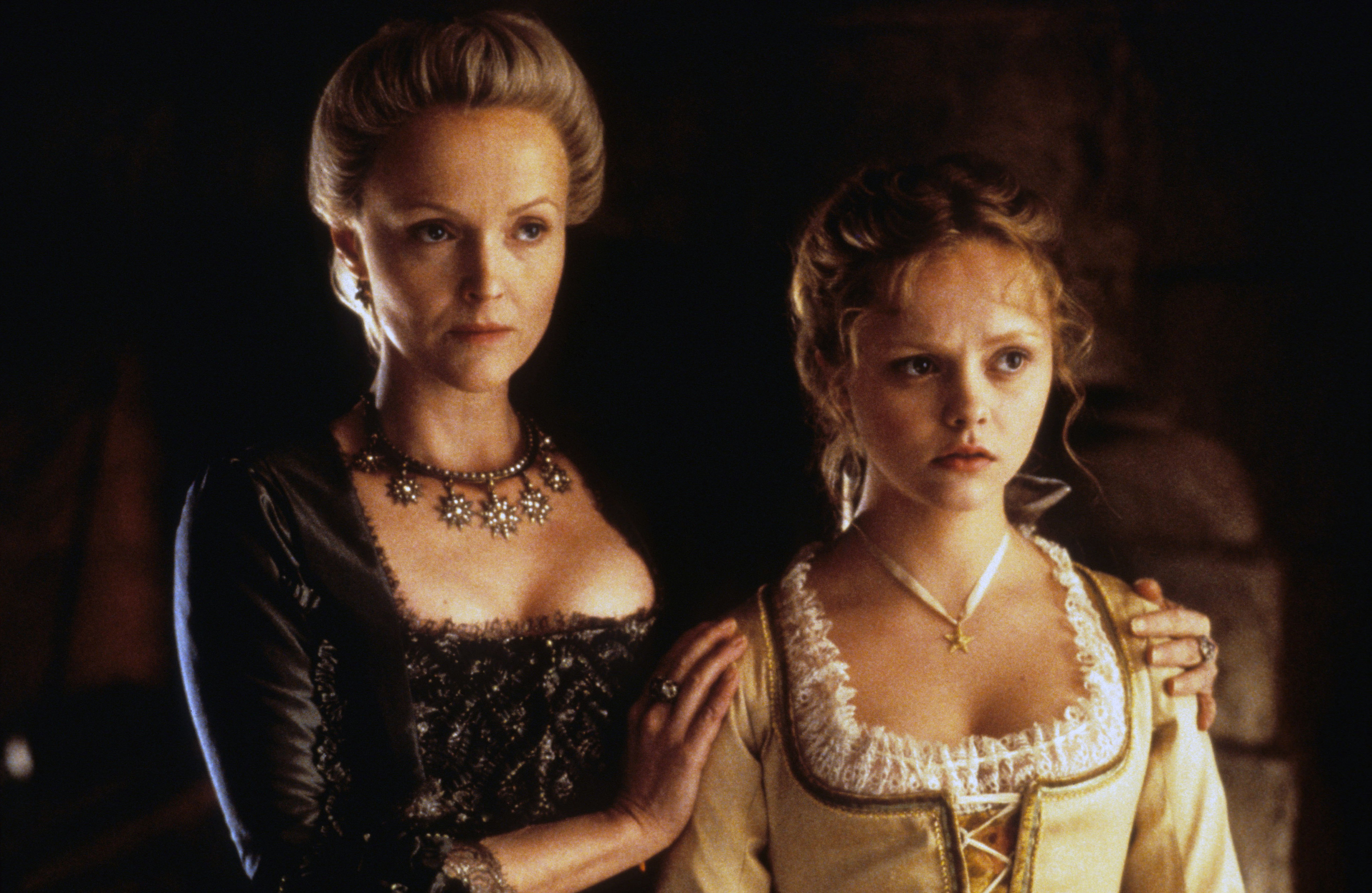 Miranda Richardson and Christina Ricci in period costumes from the movie &quot;Sleepy Hollow.&quot; Miranda wears a black dress with a jeweled necklace; Christina wears a historical white dress